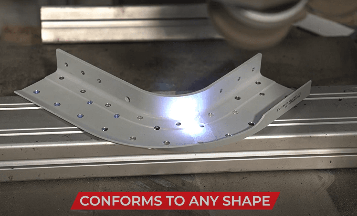 FP-300 laser cleaning a curved aircraft control surface — conforms to any shape
